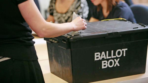 A vote being put in a ballot box